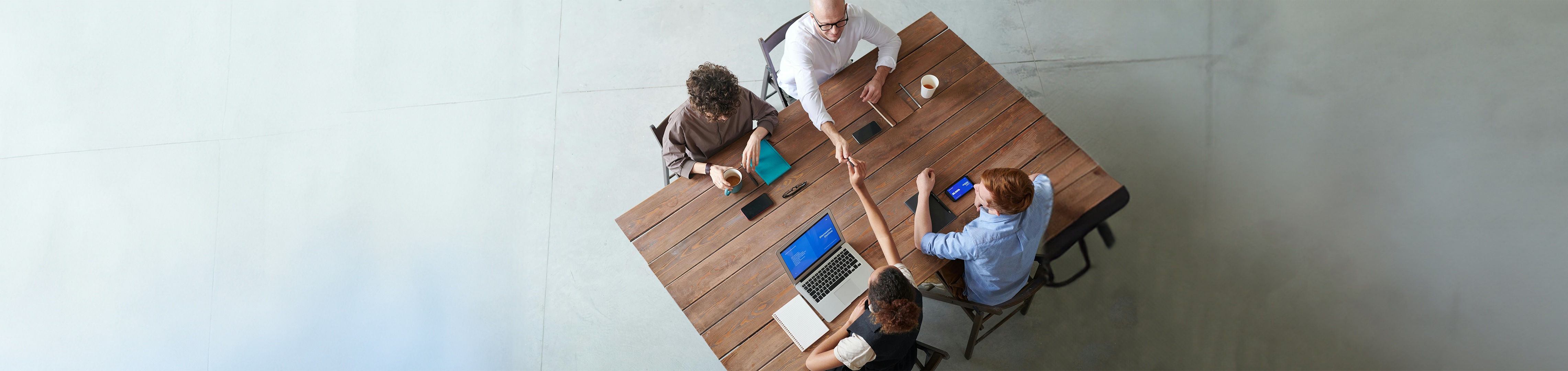 A fractional marketing team sitting around a work desk talking to each other